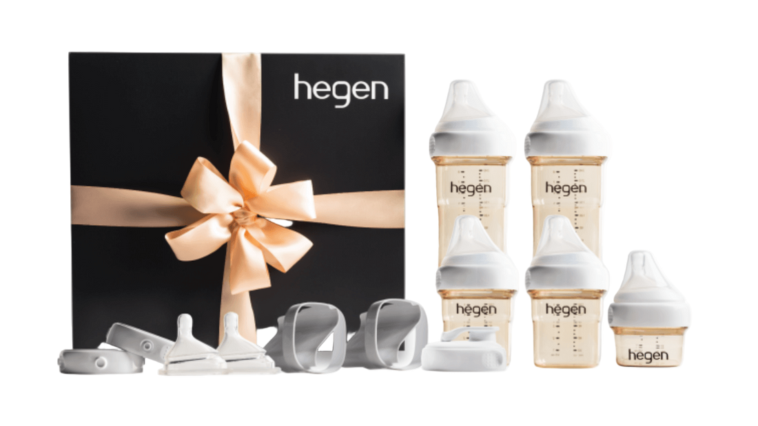 A Hegen PCTO Complete Starter Kit with various feeding bottles and accessories, presented in a black box with a gold ribbon.