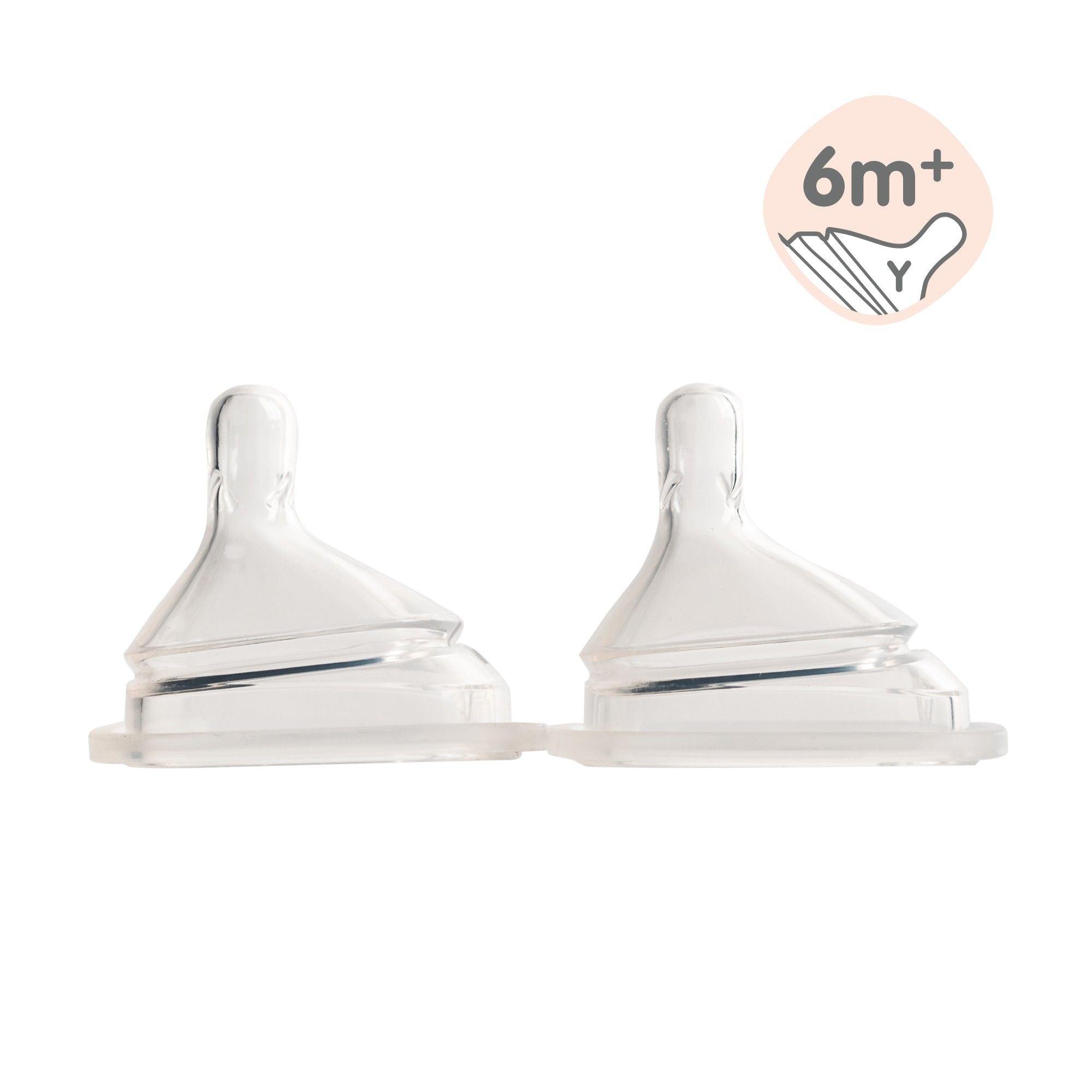 Two transparent silicone teats designed for baby bottles, marked with a &