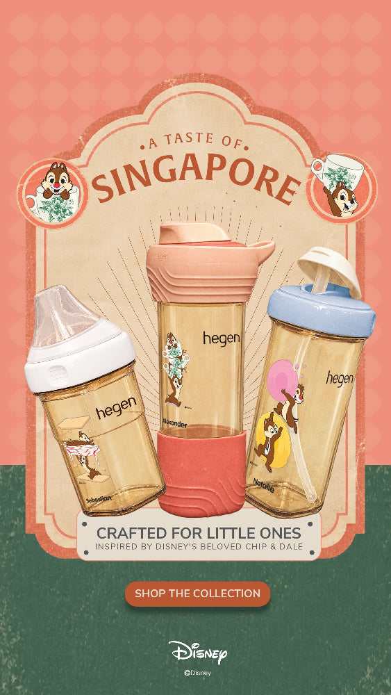 Disney Singapore collaboration with Hegen baby bottles and tumbler. The advertisement features three products: a clear baby bottle with a white lid and beige base, a pink and coral reusable tumbler with a matching pink lid, and a clear tumbler with a light blue lid and beige base.