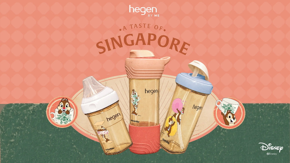 Three Hegen by Me baby bottles with Disney character illustrations, displayed on a decorative fan against a pink and green background with 'A Taste of Singapore' text.