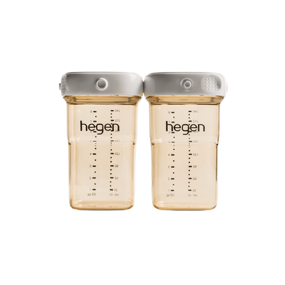 Two transparent Hegen breast milk storage containers with measurement markings and white lids.