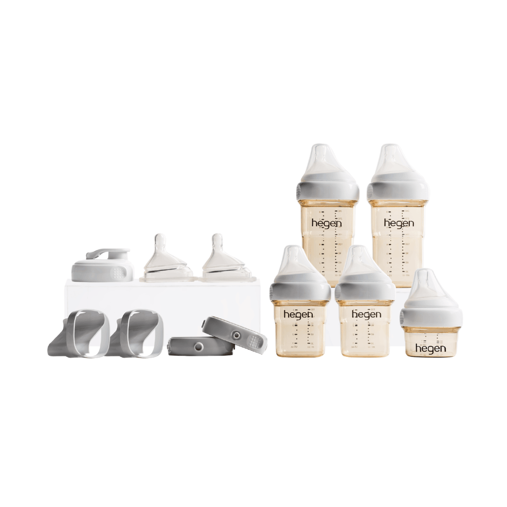 A Hegen PCTO Complete Starter Kit with various feeding bottles and accessories, presented in a black box with a gold ribbon.
