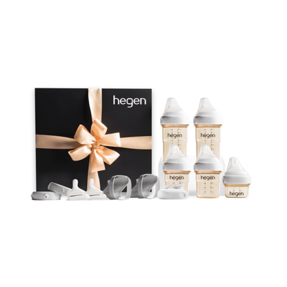 A Hegen PCTO Complete Starter Kit with various feeding bottles and accessories, presented in a black box with a gold ribbon.
