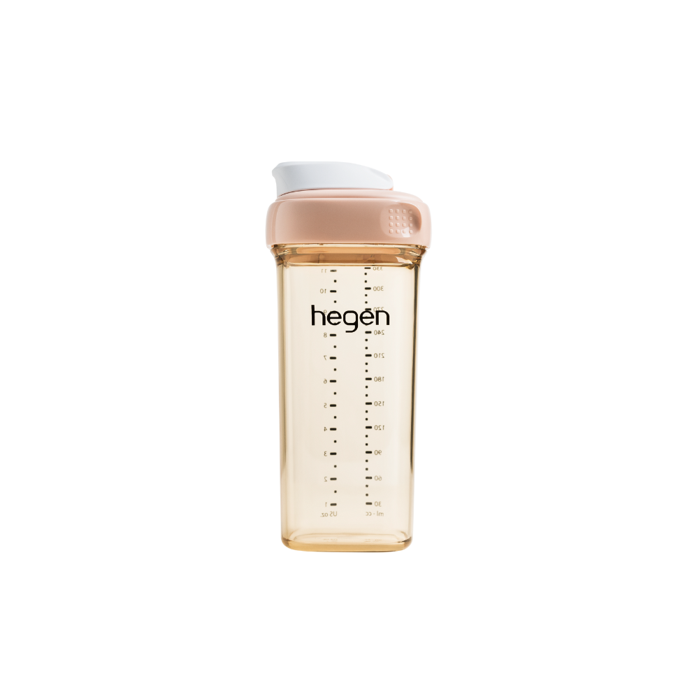 A pink Hegen PCTO drinking bottle with measurement markings on the side.