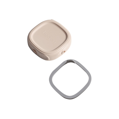 A pink Hegen breast milk storage lid with a snap-on interconnecting button, and a grey lid for storage, stacked on top of each other.