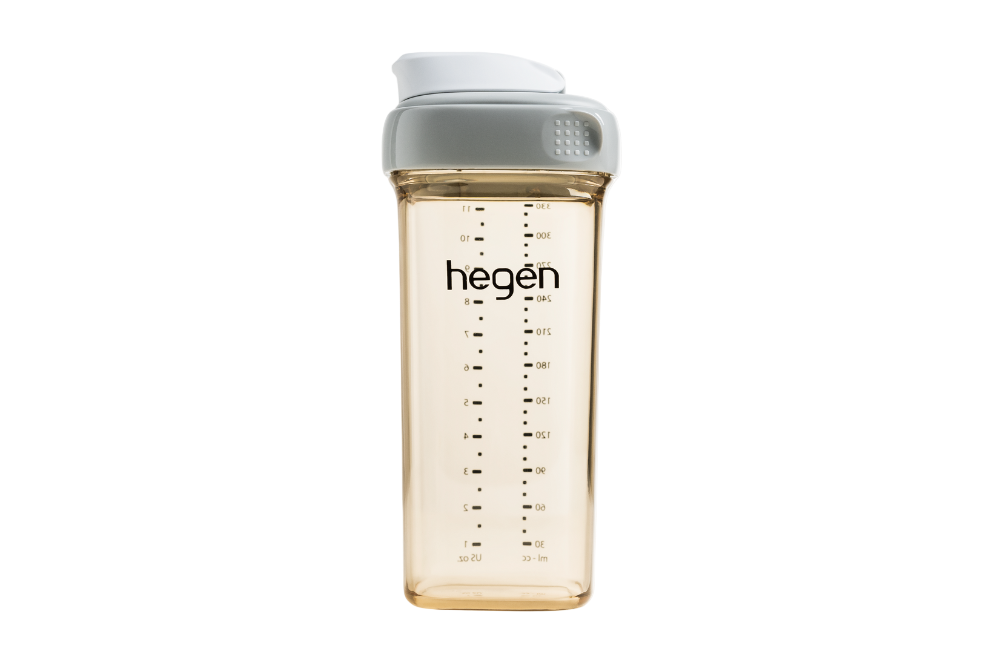 A transparent drinking bottle with gray cap and measurement markings, branded with &