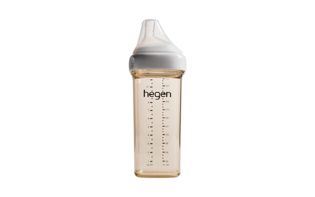 A 330ml/11oz Hegen feeding bottle with a fast flow teat designed for babies 6 months and beyond, in a clear color with measurement markings.