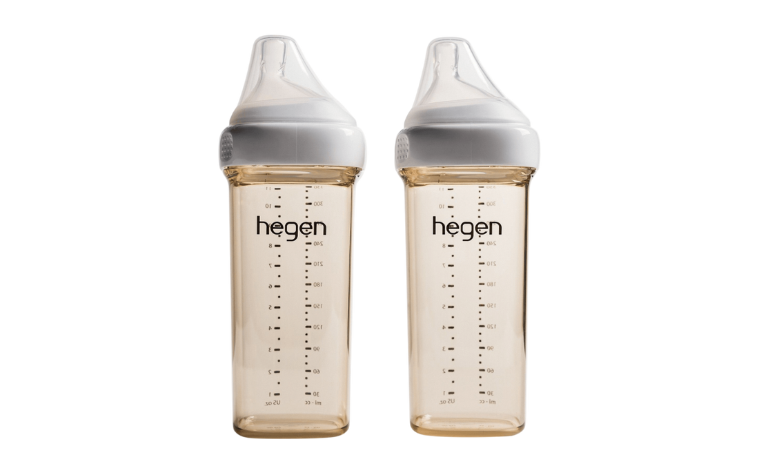 Two Hegen PCTO 330ml/11oz feeding bottles with fast flow teats, transparent with measurement markings, against a white background.