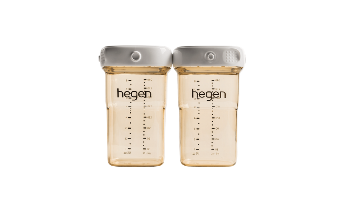Two transparent Hegen breast milk storage containers with measurement markings and white lids.