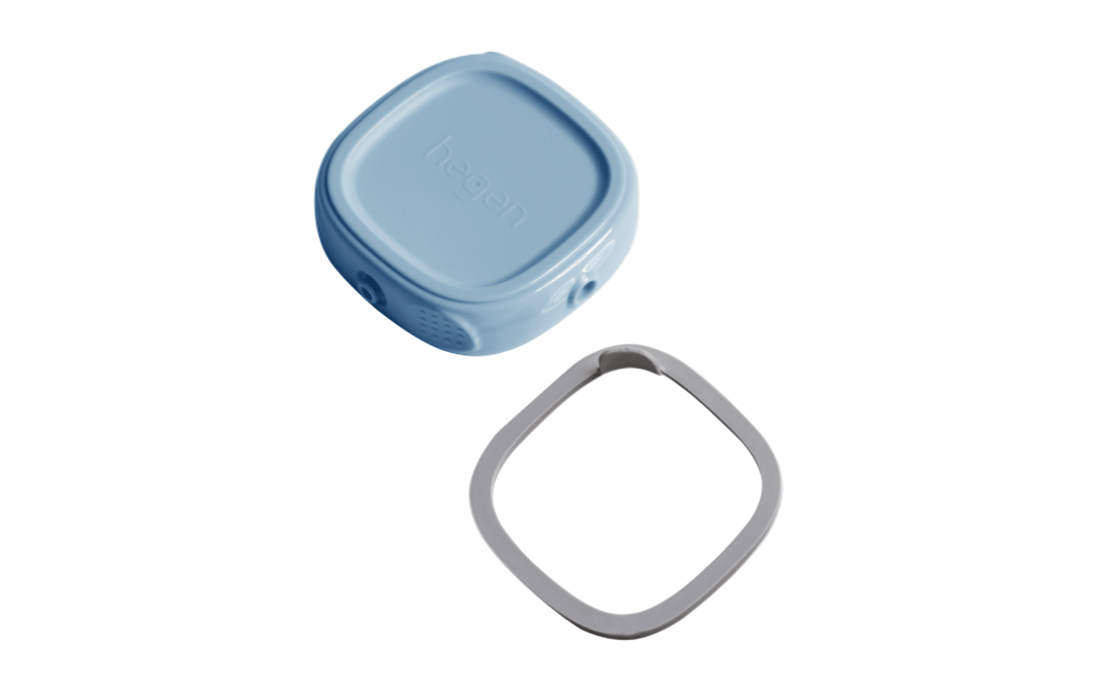 A blue Hegen breast milk storage container lid alongside its matching ring.
