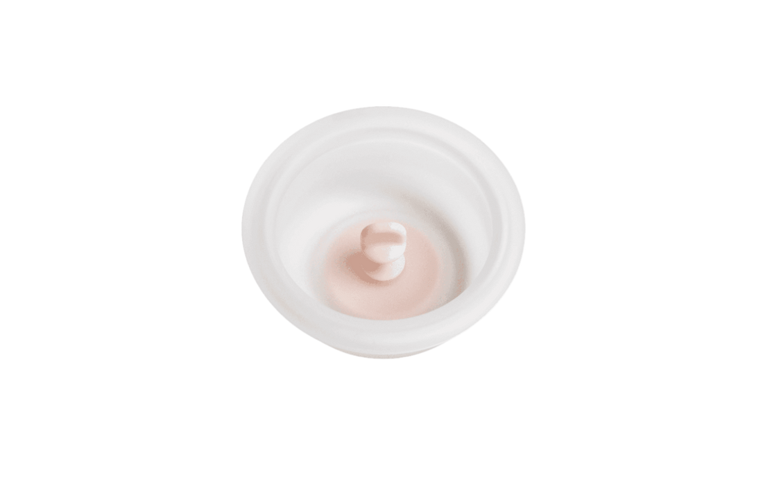 A white manual breast pump diaphragm with a soft, squishy texture, designed for use with a breast pump.